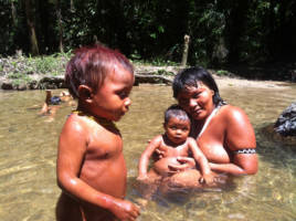 En mor bader i elven, sammen med sine to små barn